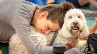 Doga (dog yoga) in the Studio at the Goodwood Kennels at the start of the first Goodwoof event..Picture date: Saturday May 28, 2022..Photograph by Christopher Ison ©.07544044177.chris@christopherison.com.www.christopherison.com..IMPORTANT NOTE REGARDING IMAGE LICENCING FOR THIS PHOTOGRAPH: This image is supplied to the client under the terms previously agreed. No sales are permitted unless expressly agreed in writing by the photographer. Sharing with third parties is prohibited without the written permission of the photographer.