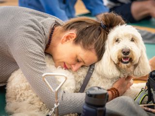 Doga (dog yoga) in the Studio at the Goodwood Kennels at the start of the first Goodwoof event..Picture date: Saturday May 28, 2022..Photograph by Christopher Ison ©.07544044177.chris@christopherison.com.www.christopherison.com..IMPORTANT NOTE REGARDING IMAGE LICENCING FOR THIS PHOTOGRAPH: This image is supplied to the client under the terms previously agreed. No sales are permitted unless expressly agreed in writing by the photographer. Sharing with third parties is prohibited without the written permission of the photographer.
