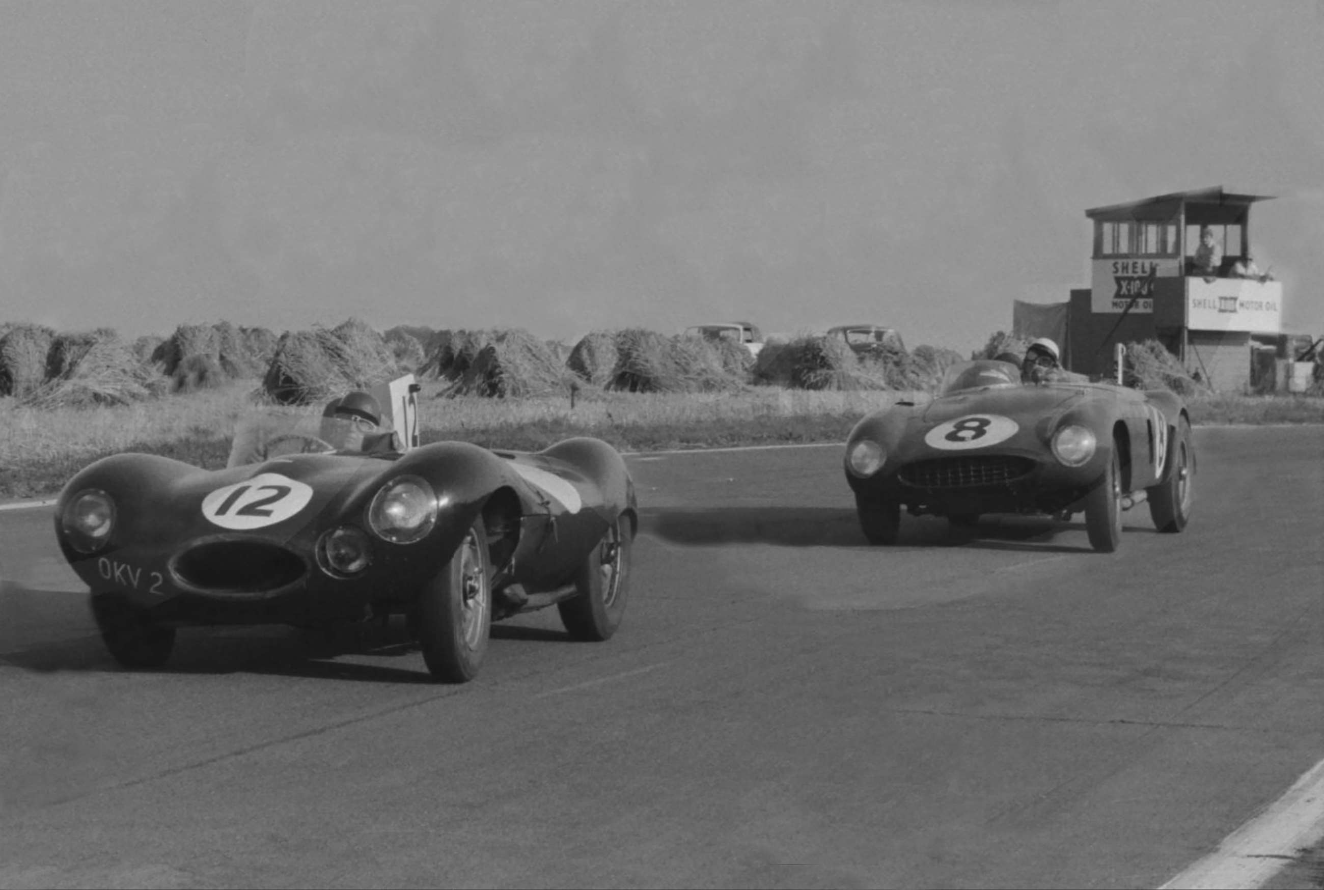 1955 Goodwood 9-Hour race. Norman Dewis in Jack Broadhead’s D-Type Jaguar - co-driven by Bob Berry - finished 5th. Seen here holding off the Harry Schell/Jean Lucas Ferrari 750 Monza through St Mary’s.