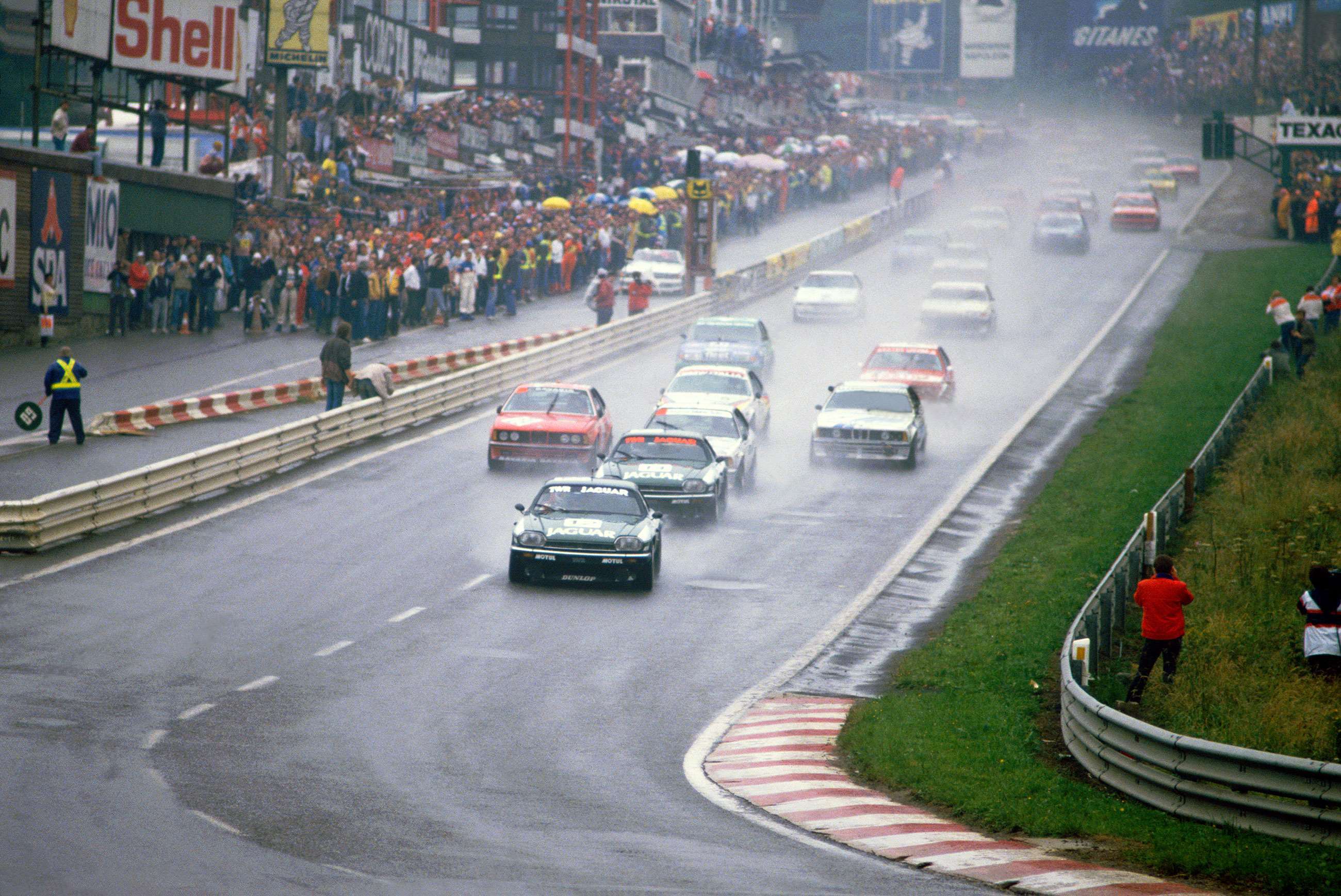 Spa 1984. The TWR Jaguar XJ-S of Tom Walkinshaw, Win Percy and Hans Heyer storms into Eau Rouge in first position.