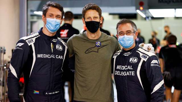 Romain Grosjean with medical car driver Alan van der Merwe (left) and Dr Ian Roberts (right), who pulled Grosjean away from the fire.